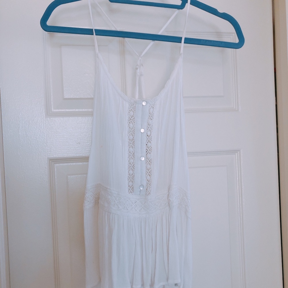 Boho white, flowy tank with lace accents.